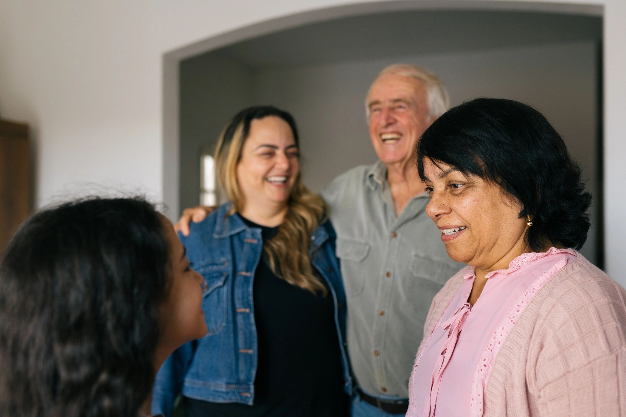 Multi-generational family smiling together indoors